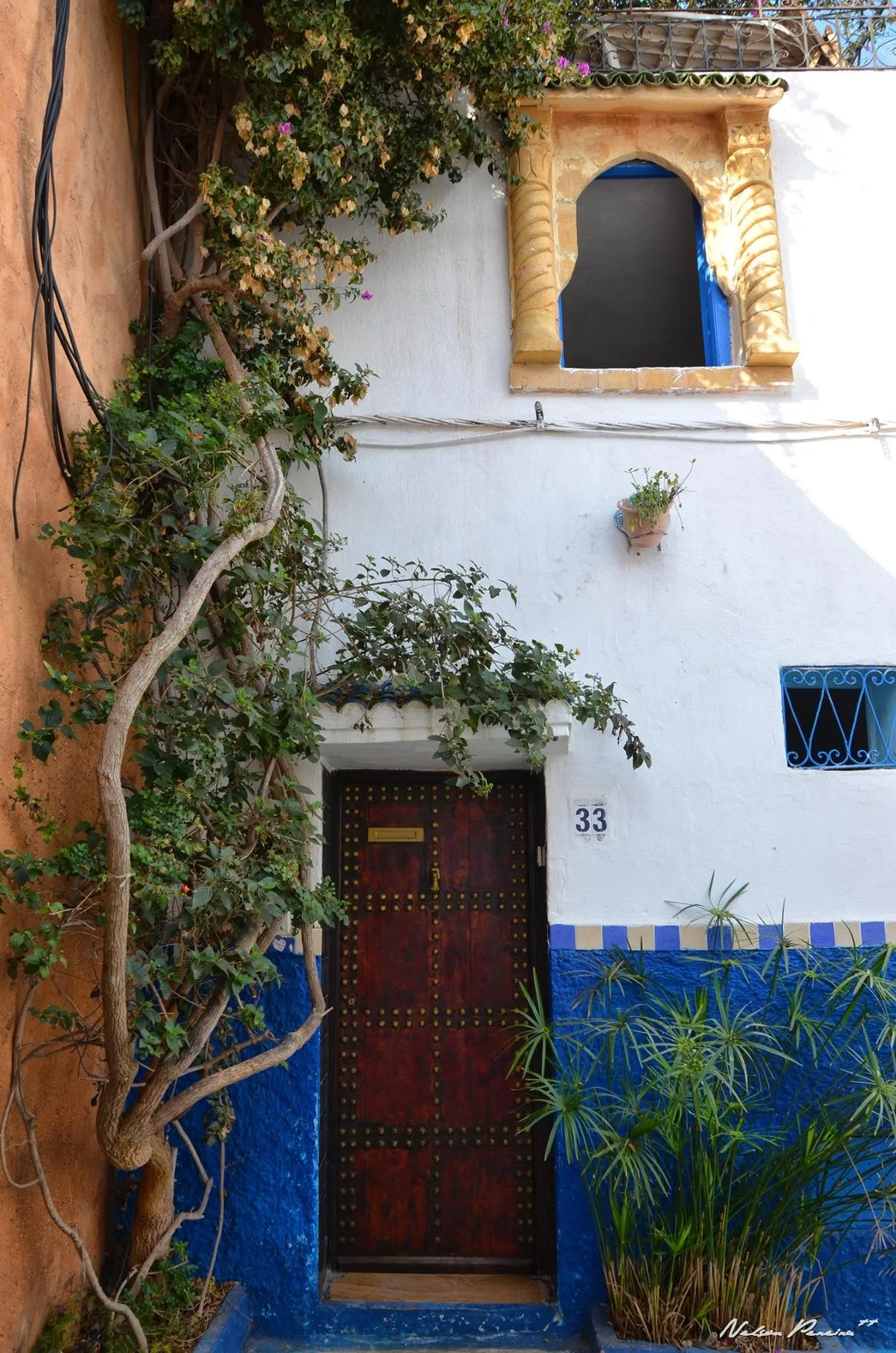 Blue and white house with a carved door in the Kasbah